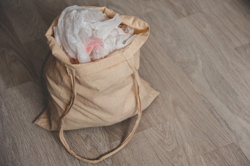 A rag bag filled with used plastic bags. Side view. Grunge style. Copy space