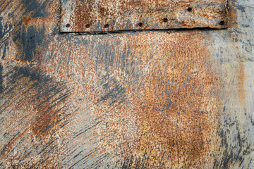 Rusty metal multicolor abstract outdoor textured grunge wall with gray, white, and orange rust pattern to be used as a background with copy space