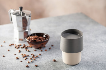 Reusable coffee mug  on a bright background. Healthy break. Reusable ware. Zero waste concept