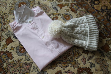 White winter cap and pink shirt white collar