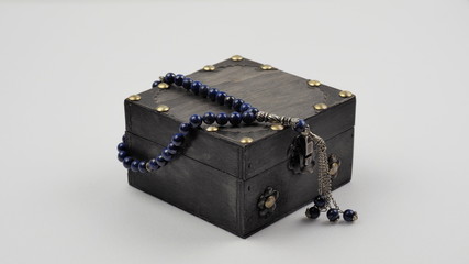 Vintage wood box with a rosary made of natural materials