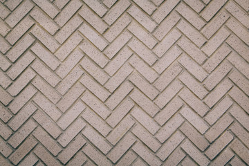 a herringbone pattern brick wall in a neutral beige brown color