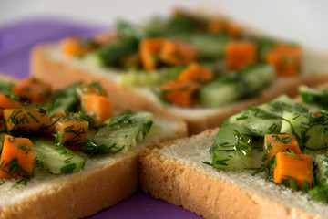 Sandwiches with carrots, cucumbers and herbs.
