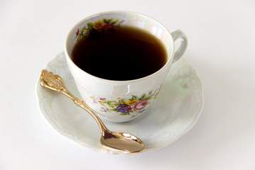 Cup of black tea on a white background
