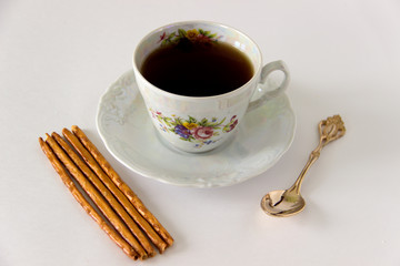 Cup of black tea with cookies
