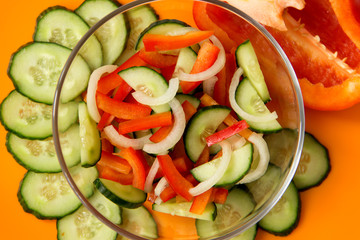 Healthy vegetable salad. View from above. Orange background