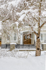 A perfect neighborhood. Fragment of a nice house in suburb at snow winter in the north America.
