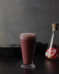 Pink latte in a glass cup