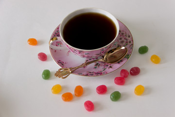 Cup of black tea with candy