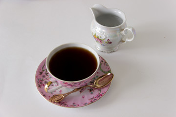 Black tea in a beautiful cup on a white background