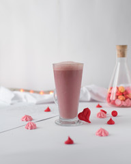 Pink latte in a glass cup