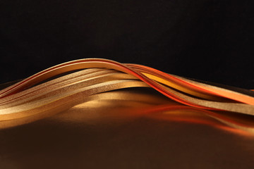 Abstract strip line background. Gold (bronze) wave on black.