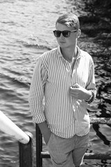 young man fashion photoshoot at the beach sunny day