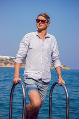 young man fashion photoshoot at the beach sunny day