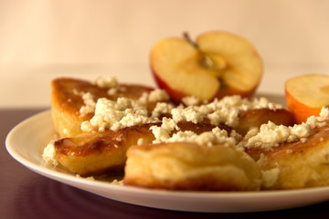 Cheesecakes with cottage cheese and apple. Side view.