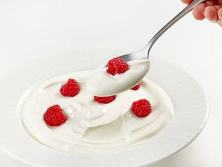 spoon of greek yogurt with raspberry