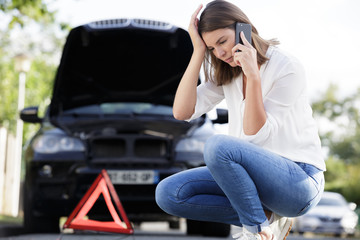 a woman calling road assistance