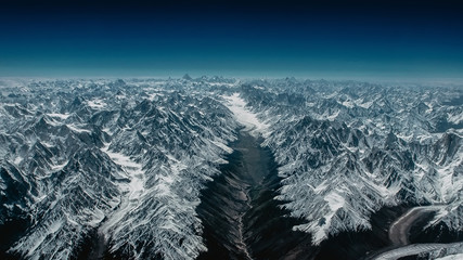 Incredible and majestic Himalayan mountains and visible Everest in the distance. View from above. Sunny, bright day.