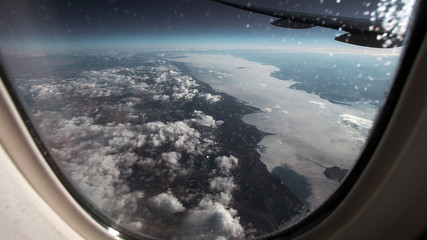 View of the frozen, winter Baikal from the airplane window.