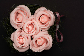 Orange soap roses with pink ribbon from above
