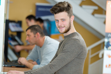 portrait of teenager using public laptop