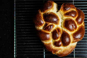 Heart-shaped challah bread on a rack