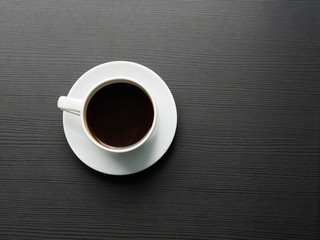 Cup of coffee on the table with copy space. Top view..Dark background.