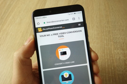KONSKIE, POLAND - May 18, 2019: hand holding smartphone with OnlineVideoConverter website on screen