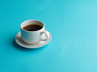 White coffee cup on blue kitchen table. Top view with copyspace for your text.