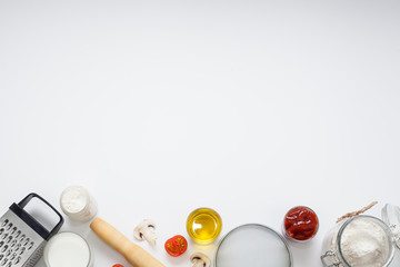 White background decorated with ingredients and appliances for cooking, baking. Concept of cooking or making food.