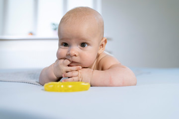 A portrait of a cute newborn baby in lying on its stomach