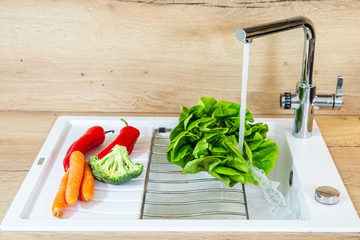 Washing lettuce leaves. Wash the vegetables in the kitchen