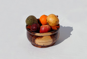 Variety of fresh fruits in a wood cauldron