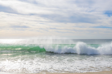 Set of pictures of a fantastic ocean wave in different stages. Cloudy sunrise sky. San Jose del Cabo. Mexico.