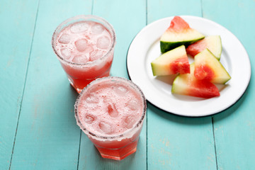 Mexican watermelon margarita cocktail on turquoise background