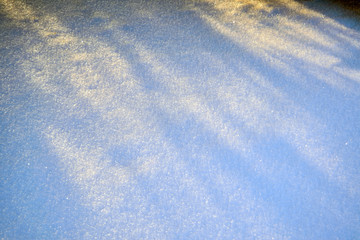 Shadows in the snow close-up. Abstract winter background.