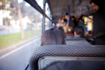 bus in Selective focus and blurred background. s the main mass transit passengers in the bus. People in old public bus, view from inside the bus .