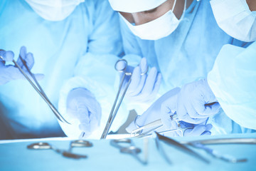 Close-up of medical team performing operation. Group of surgeons at work are busy of patient. Medicine, veterinary or healthcare and emergency in hospital