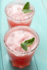 Mexican watermelon margarita cocktail on turquoise background