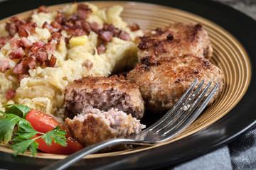 Minced meat cutlets with boiled sauerkraut.