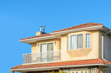 The top of the house or apartment building with nice window.