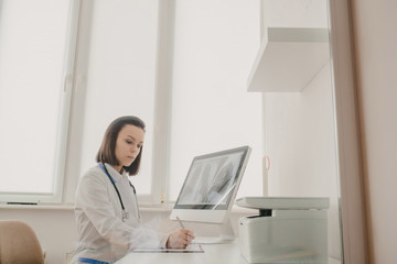 Young woman radiologist doctor analysis x-ray