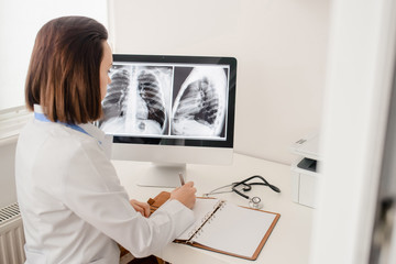 Young woman radiologist doctor analysis x-ray