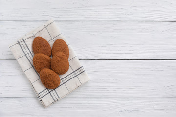 Easter egg shaped gluten free ginger cookies on the kitchen towel background, selective focus