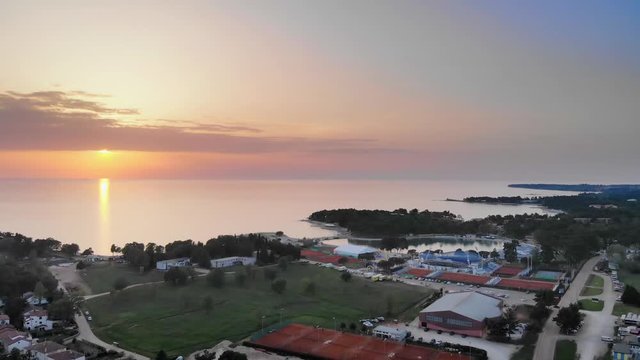 Sunset and sun in the evening time at a seaside town Umag, Croatia. View is beautiful in summer time.