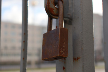 Old rusty iron gate lock. Protection against thieves.