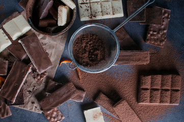 white and black chocolate on a wooden table with orange and knife