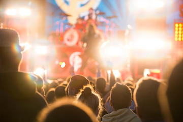 Concert and music festival background with hands raised and party people. 
