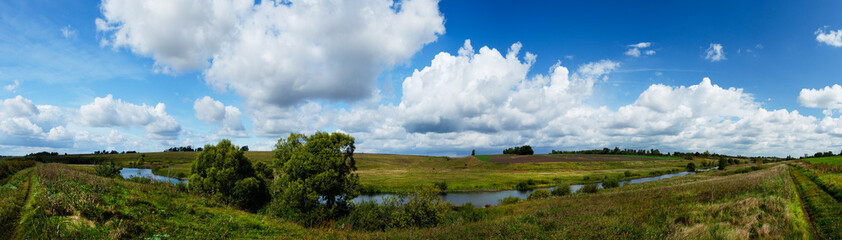 Obraz premium summer rural landscape with road and clouds