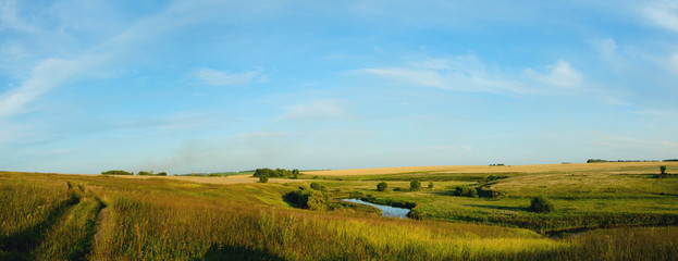 Fototapeta na wymiar landscape with wheat fields and blue sky